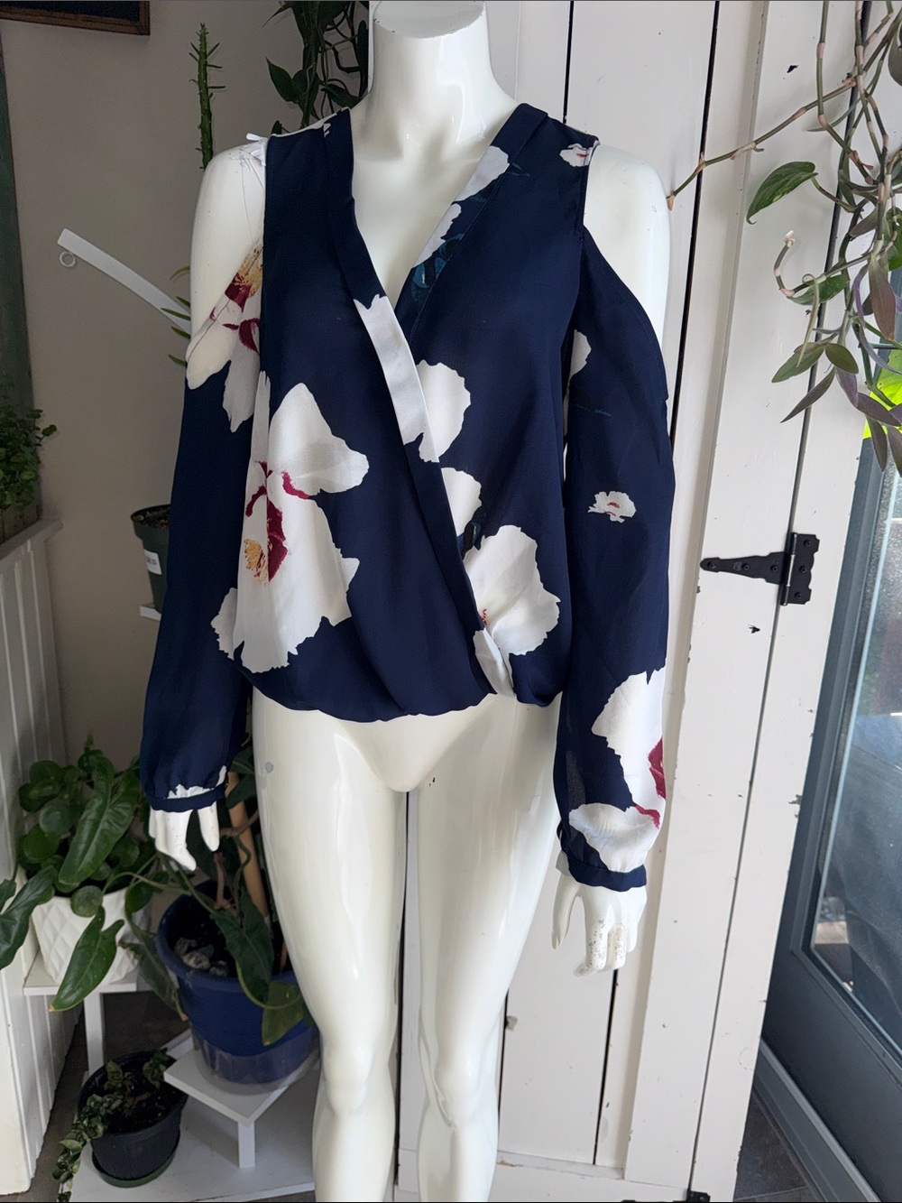 Dynamite cold-shoulder floral blouse in navy blue. It features a lightweight M